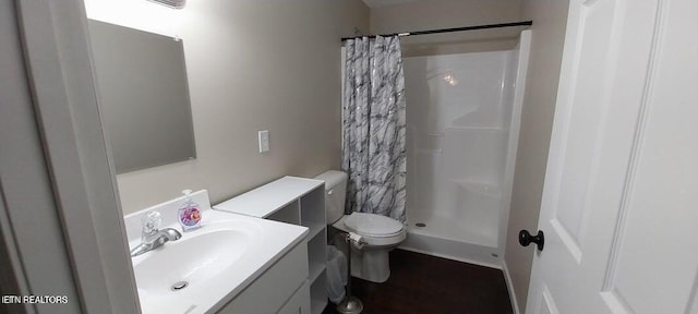 bathroom featuring vanity, toilet, and walk in shower