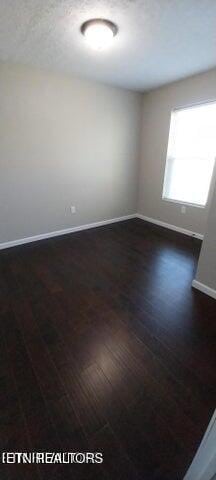 empty room with dark hardwood / wood-style floors