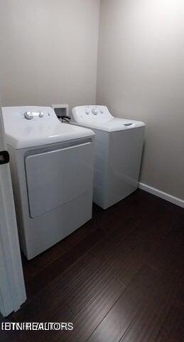 laundry area with separate washer and dryer and dark hardwood / wood-style floors