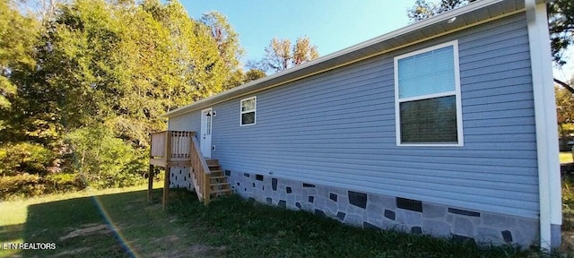 view of side of property featuring a deck