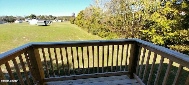 wooden deck featuring a yard