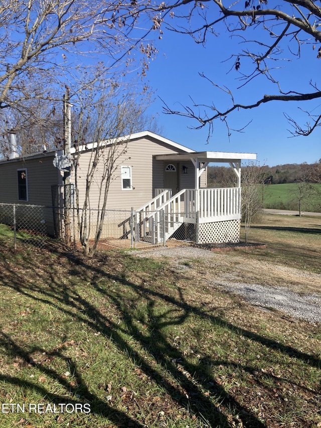 back of property featuring a yard