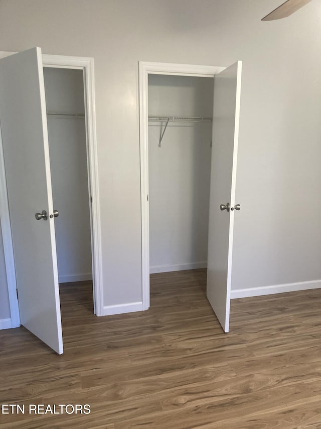 unfurnished bedroom featuring dark hardwood / wood-style flooring and ceiling fan