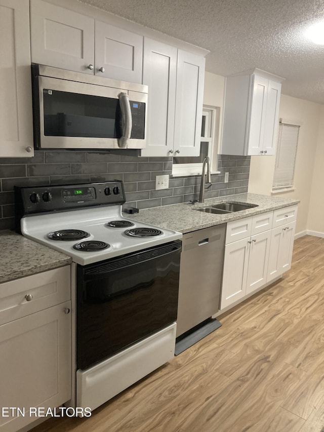 kitchen with white cabinets, sink, and stainless steel appliances