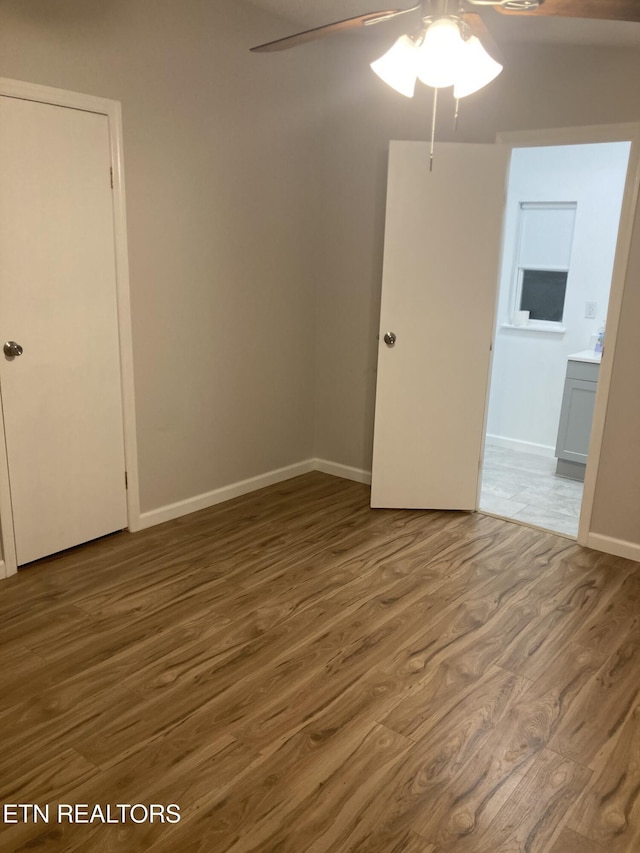 unfurnished room with hardwood / wood-style floors and ceiling fan