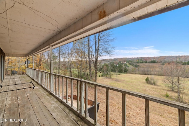 wooden terrace with a rural view