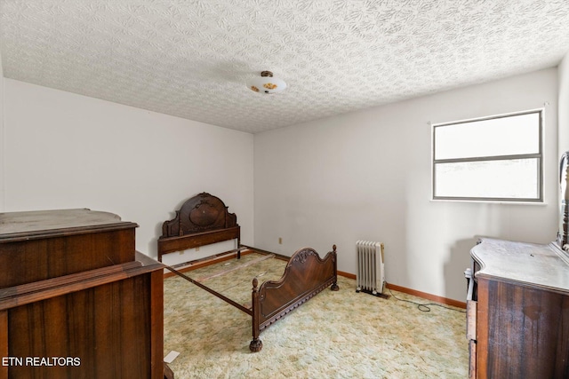 bedroom with a textured ceiling, light carpet, and radiator