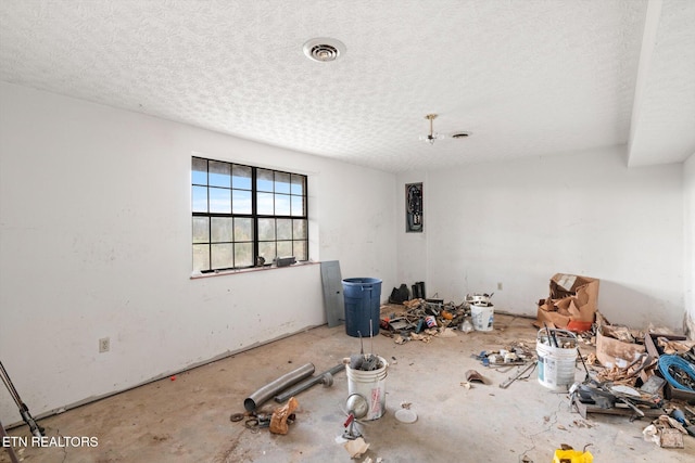 unfurnished room with a textured ceiling