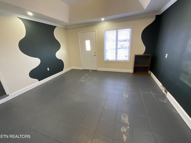 tiled foyer entrance with crown molding