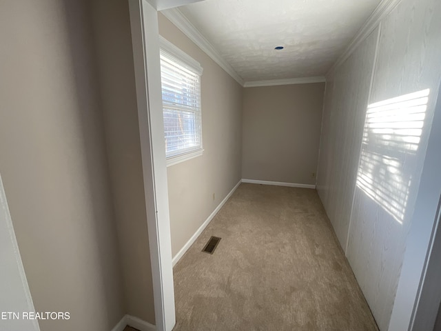 hallway with light colored carpet and ornamental molding