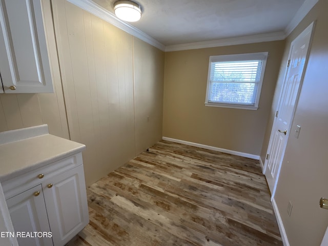 interior space with crown molding and light hardwood / wood-style floors