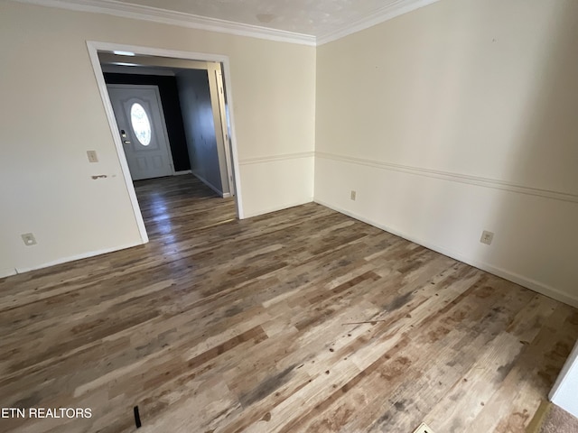 unfurnished room featuring crown molding and dark wood-type flooring