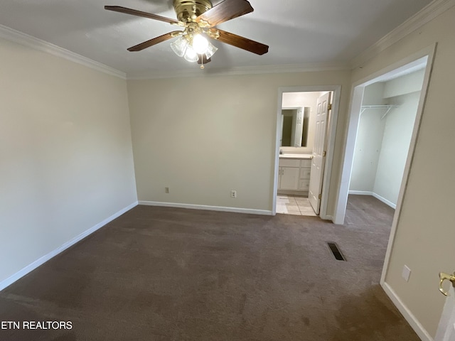 empty room featuring ceiling fan, carpet, and ornamental molding