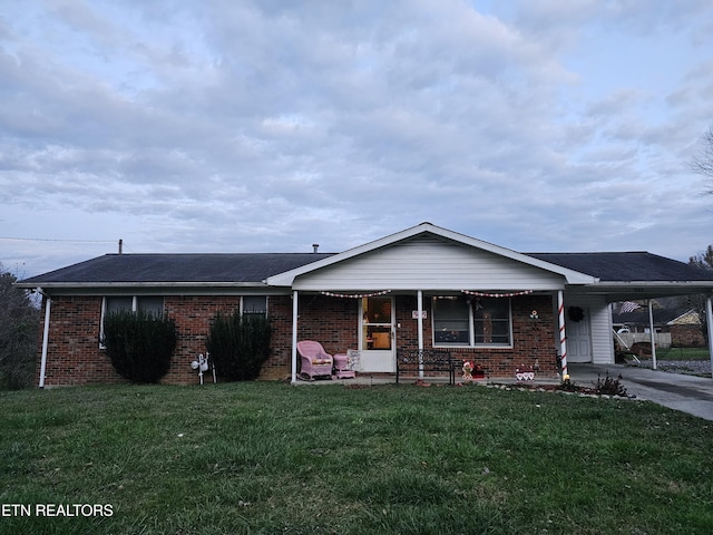 ranch-style house with a carport and a front lawn