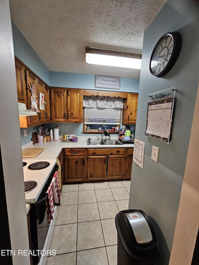 kitchen with white range with electric cooktop, ventilation hood, sink, a textured ceiling, and light tile patterned flooring