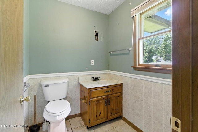 505 S S 38th St, Middlesboro, KY 40965 - bathroom with tile walls, wainscoting, tile patterned flooring, vanity, and a textured ceiling