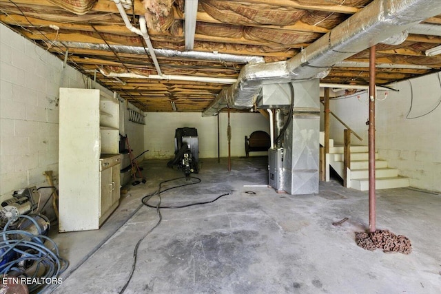 505 S S 38th St, Middlesboro, KY 40965 - unfinished below grade area with heating unit, stairs, and concrete block wall