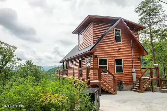 back of property with a patio area and a wooden deck