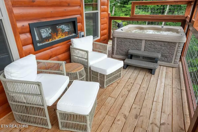 wooden deck featuring a stone fireplace