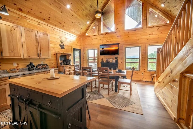 kitchen featuring light hardwood / wood-style floors, a kitchen island, high vaulted ceiling, butcher block countertops, and wooden ceiling