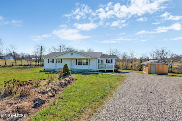 single story home featuring a shed, a front lawn, and a porch