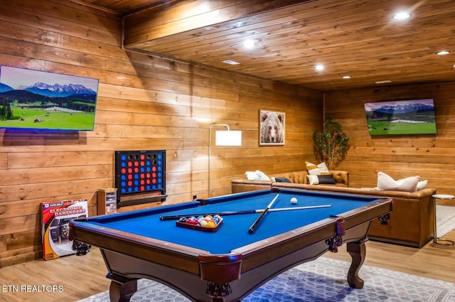 game room featuring light hardwood / wood-style floors, wooden walls, and pool table