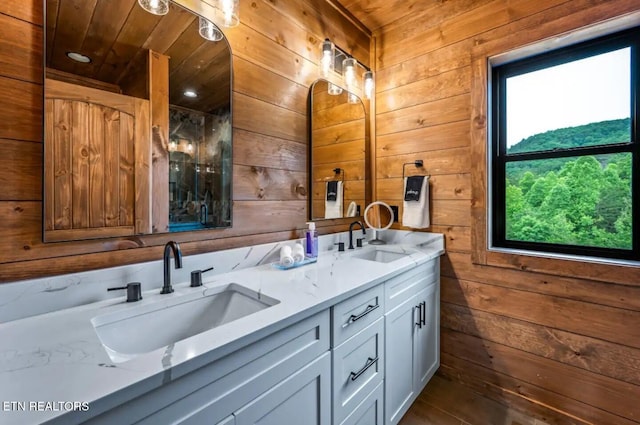 bathroom with vanity, wood ceiling, and wooden walls