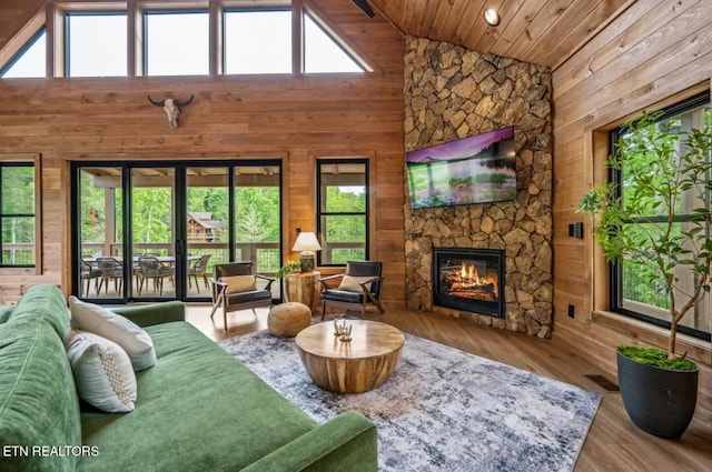 living room with a healthy amount of sunlight and high vaulted ceiling