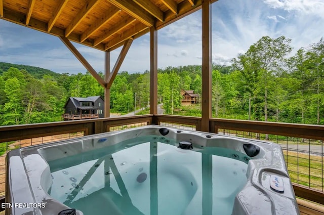 view of swimming pool featuring a hot tub