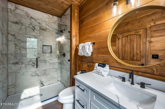 bathroom featuring vanity, wooden walls, wood-type flooring, toilet, and a shower with shower door