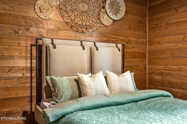 bedroom featuring wooden walls