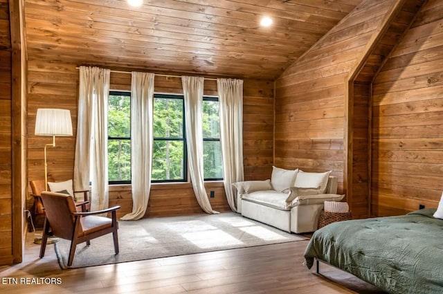 bedroom with hardwood / wood-style floors, wooden walls, lofted ceiling, and wood ceiling