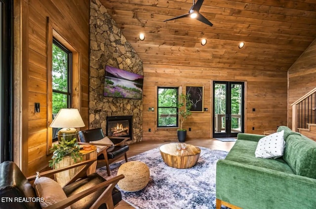 living room with a healthy amount of sunlight, wood-type flooring, and wood ceiling