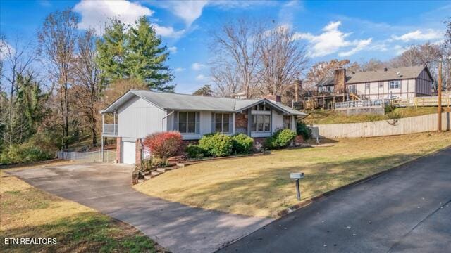 view of front of property with a front yard and a garage