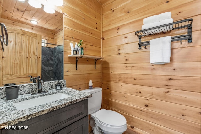 bathroom featuring toilet, wooden walls, wooden ceiling, and vanity