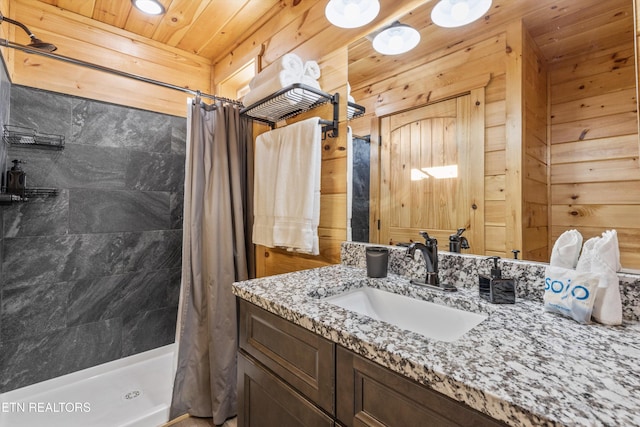 bathroom with a shower with curtain, wooden walls, and vanity