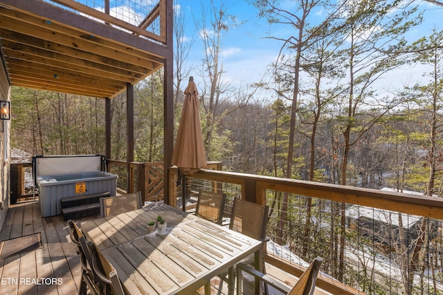 wooden deck with a hot tub