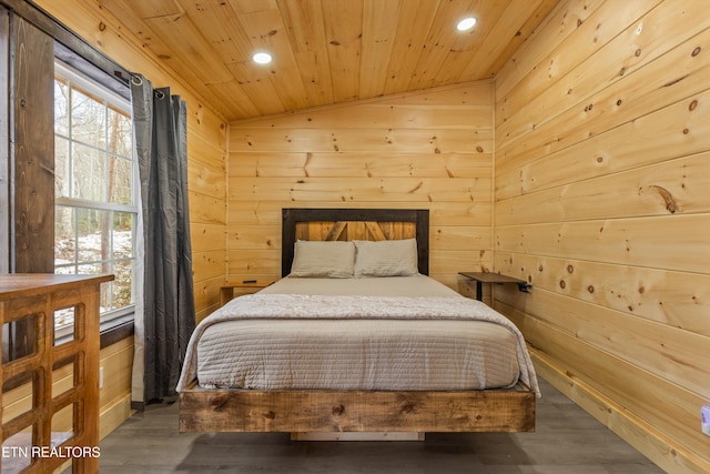 bedroom featuring dark hardwood / wood-style flooring, wooden ceiling, vaulted ceiling, and wood walls