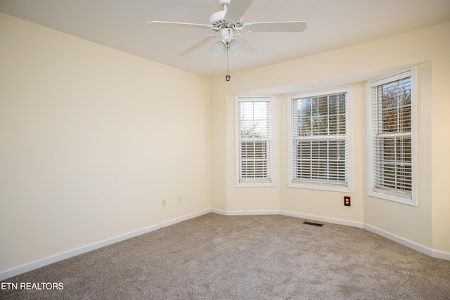 empty room with ceiling fan and carpet floors