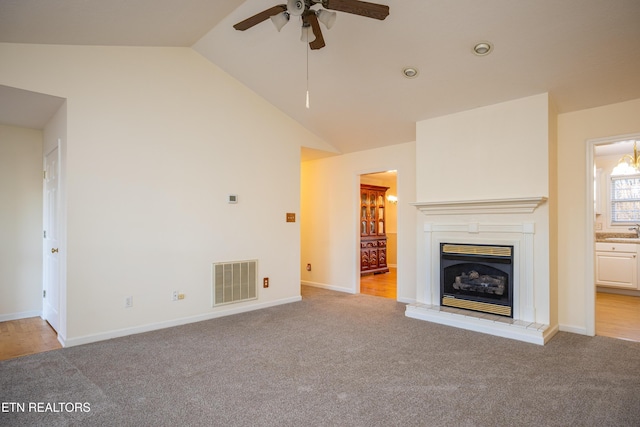 unfurnished living room with light carpet, sink, ceiling fan, and lofted ceiling