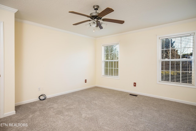 empty room featuring light carpet, ceiling fan, and ornamental molding