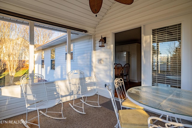 sunroom with ceiling fan and vaulted ceiling