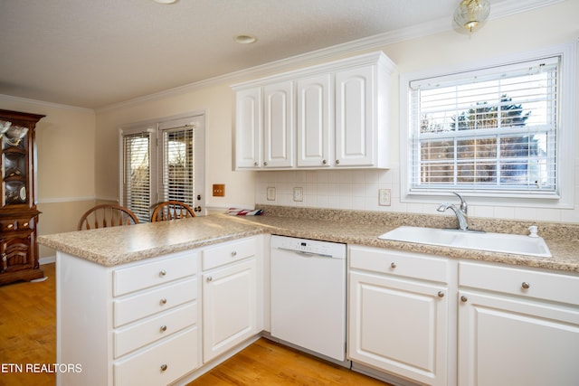 kitchen with white cabinetry, sink, light hardwood / wood-style flooring, kitchen peninsula, and white dishwasher