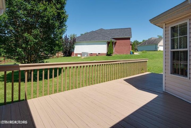 wooden terrace with a lawn