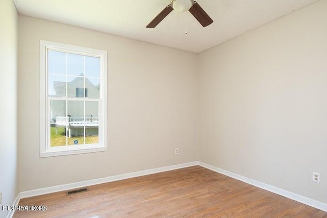 empty room with ceiling fan, light hardwood / wood-style flooring, and a healthy amount of sunlight