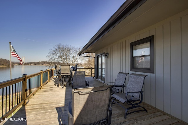 wooden terrace featuring a water view