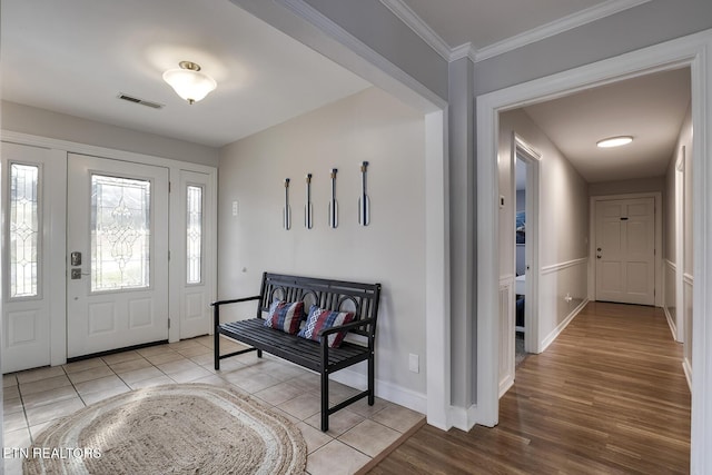 tiled foyer entrance with ornamental molding