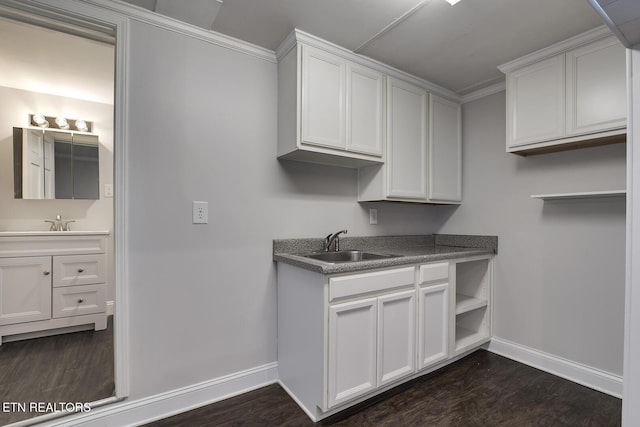 kitchen with sink, dark hardwood / wood-style flooring, and white cabinetry