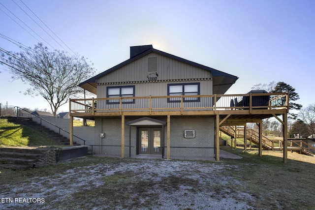 rear view of house featuring french doors and a deck