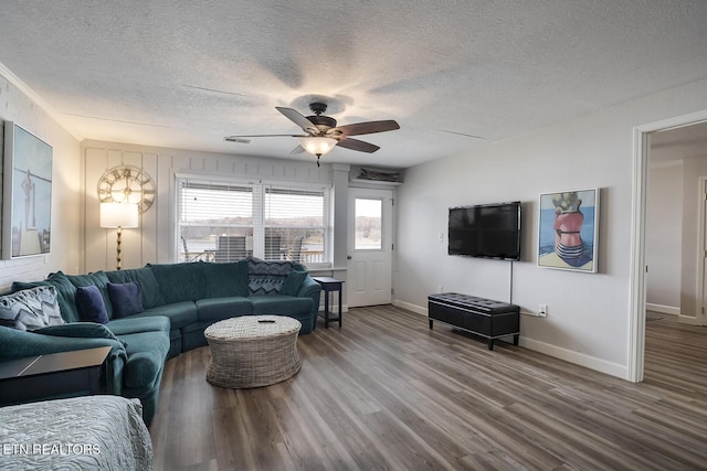 living room featuring a textured ceiling, ceiling fan, and hardwood / wood-style flooring